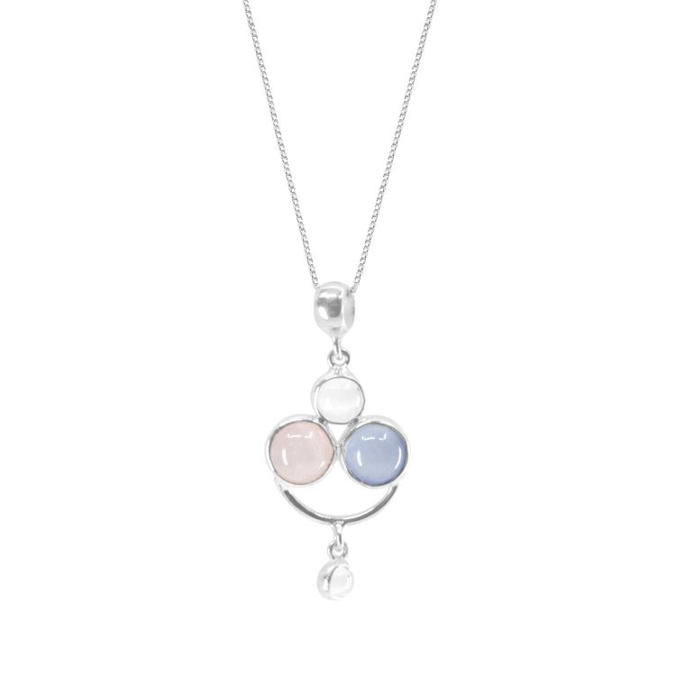 The Kaora Sandara Jewelry Happy Parents Pendant, crafted in sterling silver, showcases three circular stones in pale pink, white chalcedony, and light blue arranged in a triangular design. A smaller white Rose Quartz stone delicately dangles below the main pendant.