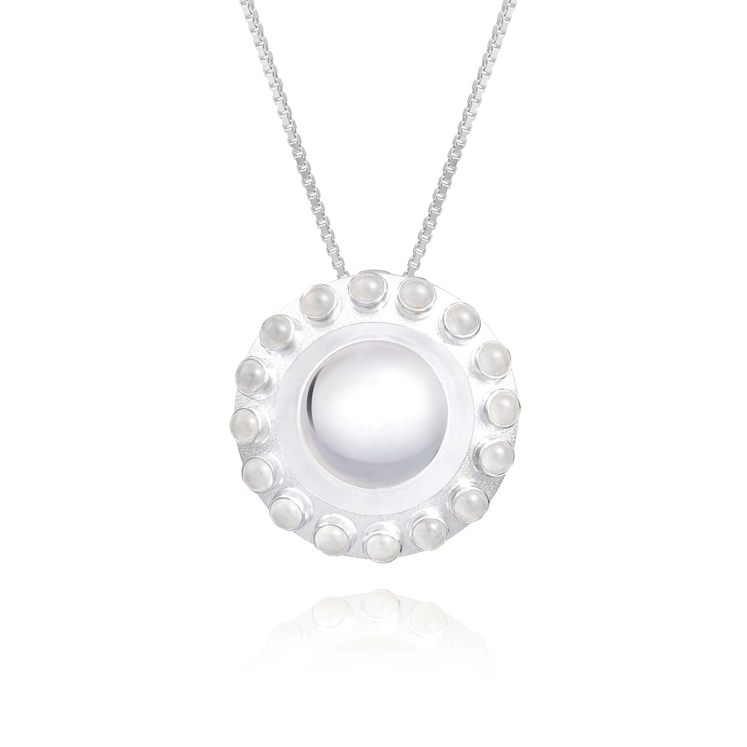 The Silver Pendant Energy Transformer with Crystal from Kaora Sandara Jewelry features a circular design, showcasing a smooth white center adorned with a decorative border of small pearl-like beads and shimmering rhinestone crystals, all elegantly suspended on a delicate chain.