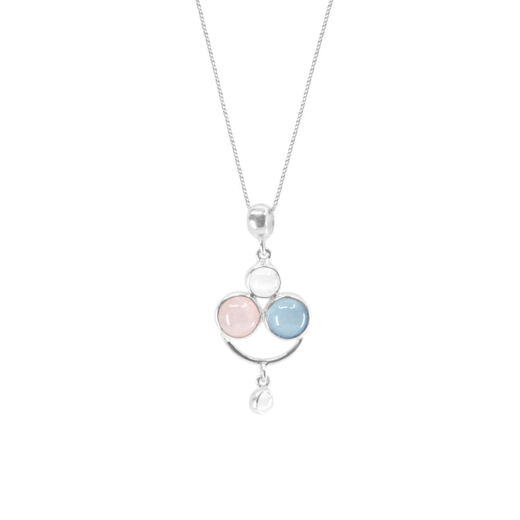 The Happy Parents Pendant from Kaora Sandara Jewelry is a sterling silver necklace featuring three circular gemstones: a rose quartz on the left, a crystal on top, and a chalcedony on the right. Additionally, a small circular crystal dangles below the pendant. This elegant piece, also known as a motherhood pendant, is suspended from a delicate silver chain.