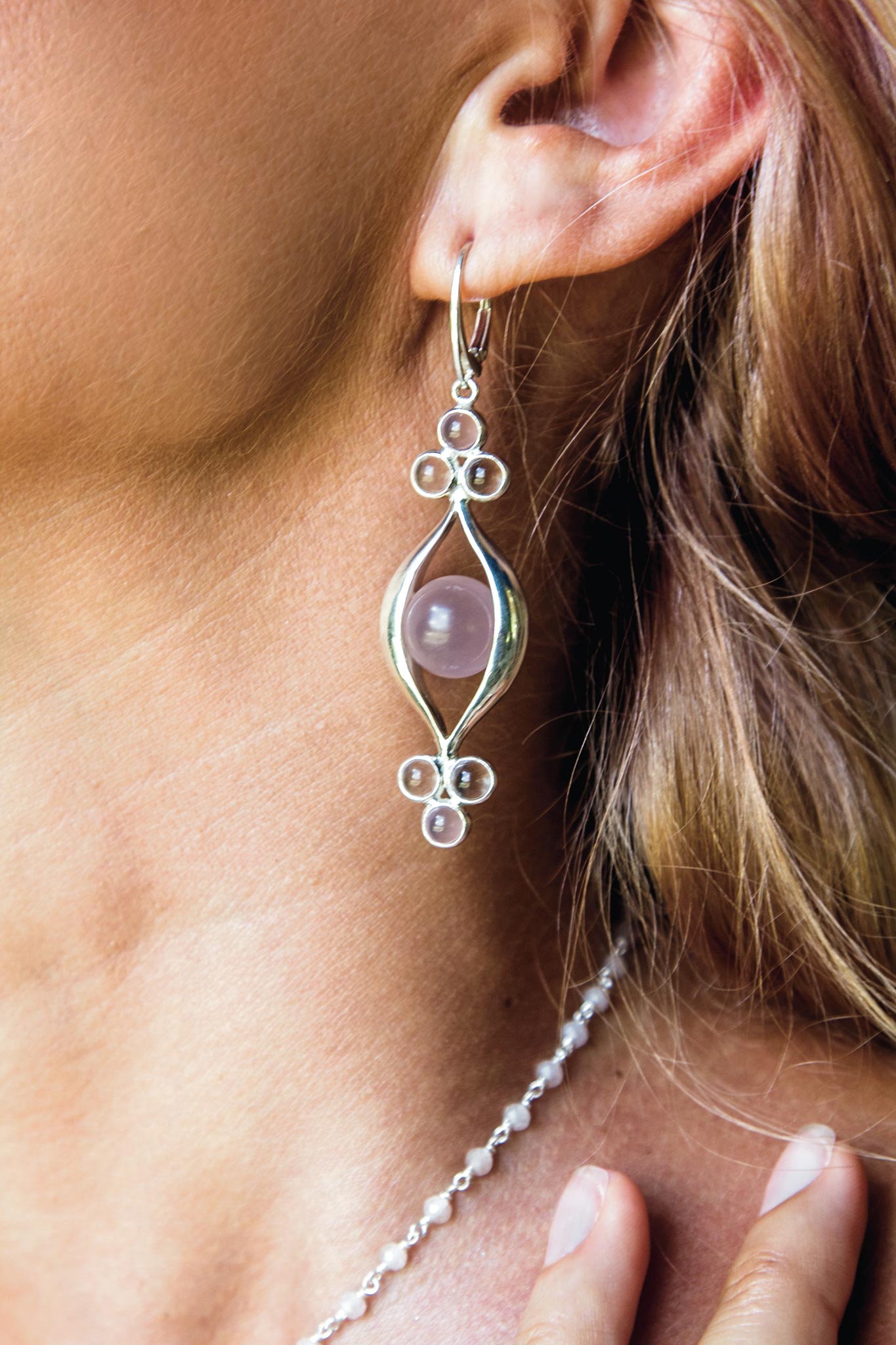 A pair of kaora sandara sterling silver 925 earrings glinting in the light.