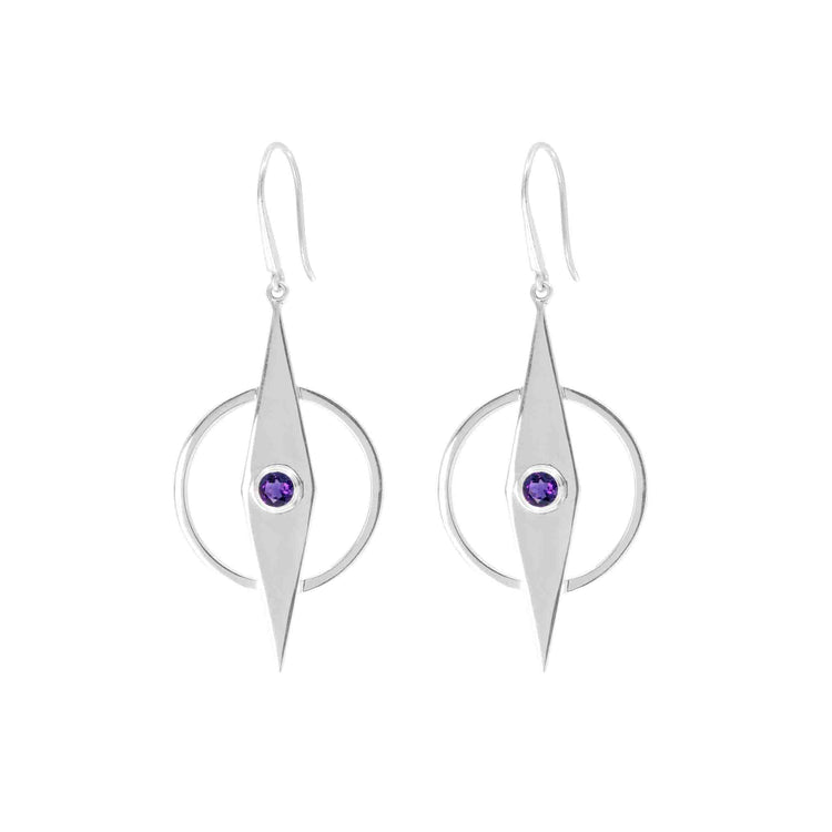 A pair of Kaora Sandara Jewelry’s Intuition Earhooks – Sterling Silver with Amethyst featuring a geometric design. Each earring has a central diamond-shaped element with a small dark purple amethyst gemstone in the center. The diamond shape is framed by a circular hoop, ensuring they hang gracefully.