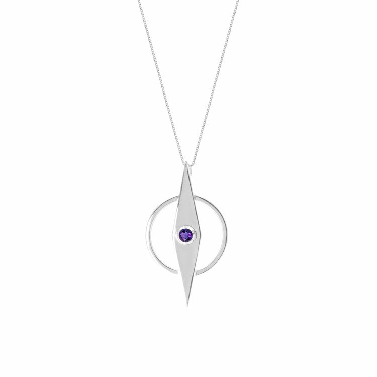 The Intuition Pendant by Kaora Sandara Jewelry boasts a Sterling Silver 925 necklace with a geometric design. An elongated diamond shape, vertically aligned and intersecting a circular frame, showcases a small amethyst gemstone at its center. This elegant piece is suspended on a delicate chain.