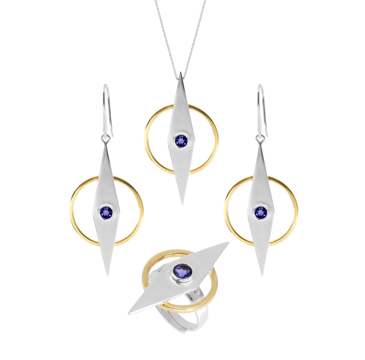 A jewelry set from the Kaora Sandara Jewelry Intuition series consists of a necklace, earrings, and an Intuition Ring – Sterling Silver & Gold-Plated with Amethyst. Each piece features a geometric design with a pointed Sterling Silver 925 teardrop shape and a circular gold accent, centered around a blue gemstone set in each teardrop. The necklace is on a thin chain.