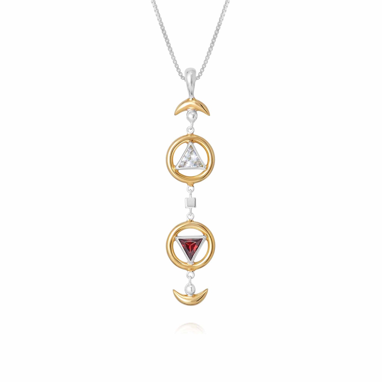 Introducing the Resource Pendant by Kaora Sandara Jewelry: a sterling silver and gold-plated necklace featuring a stunning vertical arrangement of three mesmerizing symbols – a crescent moon, a triangle adorned with a white Rhinestone Crystal, and an inverted triangle showcasing a radiant red garnet. The delicate, thin chain enhances the understated elegance of this exquisite piece.