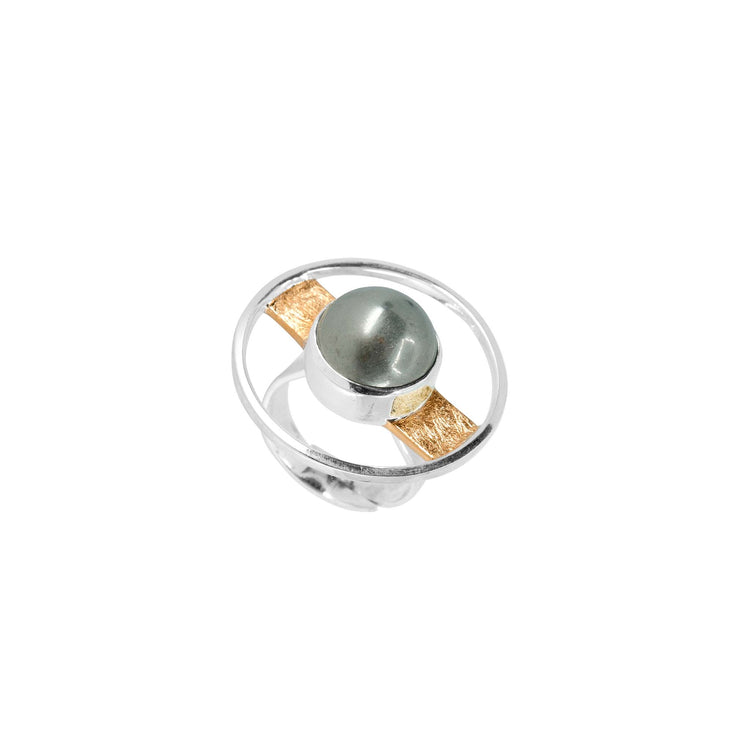 Introducing the Animus Ring from Kaora Sandara Jewelry: a sterling silver ring featuring a distinctive open circular design with a striking pyrite sphere at its center. The sphere is elegantly accompanied by a horizontal gold-plated bar that stretches across the diameter of the ring's open circle, endowing it with masculine qualities and an avant-garde, artistic charm.