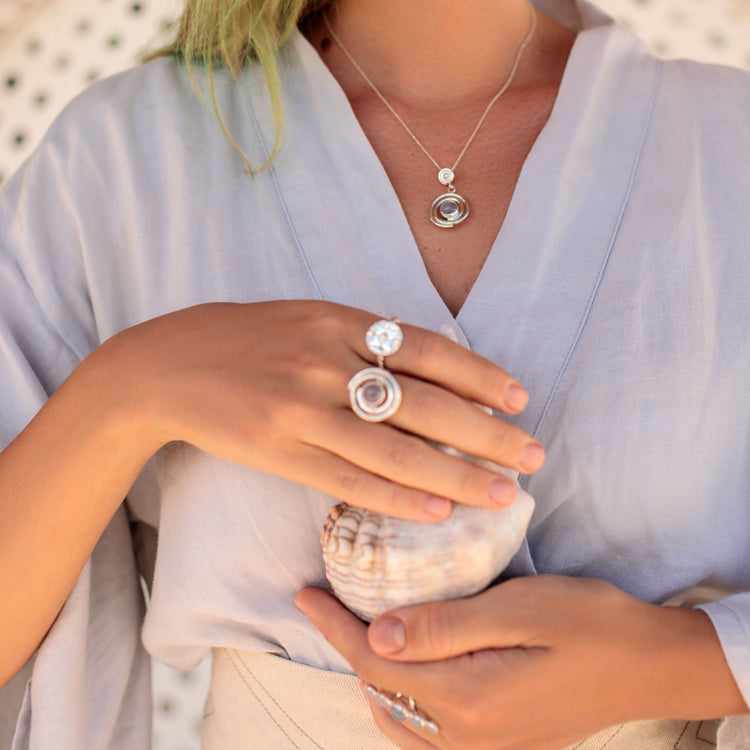 Spiral jewelry piece symbolizing infinite development and progress. Different gems accentuate its beauty, with rock crystal amplifying intuition and balancing spiritual-physical energies, enhancing psychic abilities, and offering healing effects.