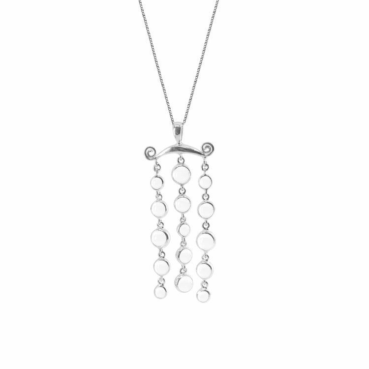 The Magic Path Pendant by Kaora Sandara Jewelry - a delicate Sterling Silver 925 necklace featuring a unique design. The pendant consists of a horizontal bar with two small spiral accents on each end, from which hang three vertical chains adorned with small silver circles and crystal gemstones. The necklace has a thin, elegant chain.