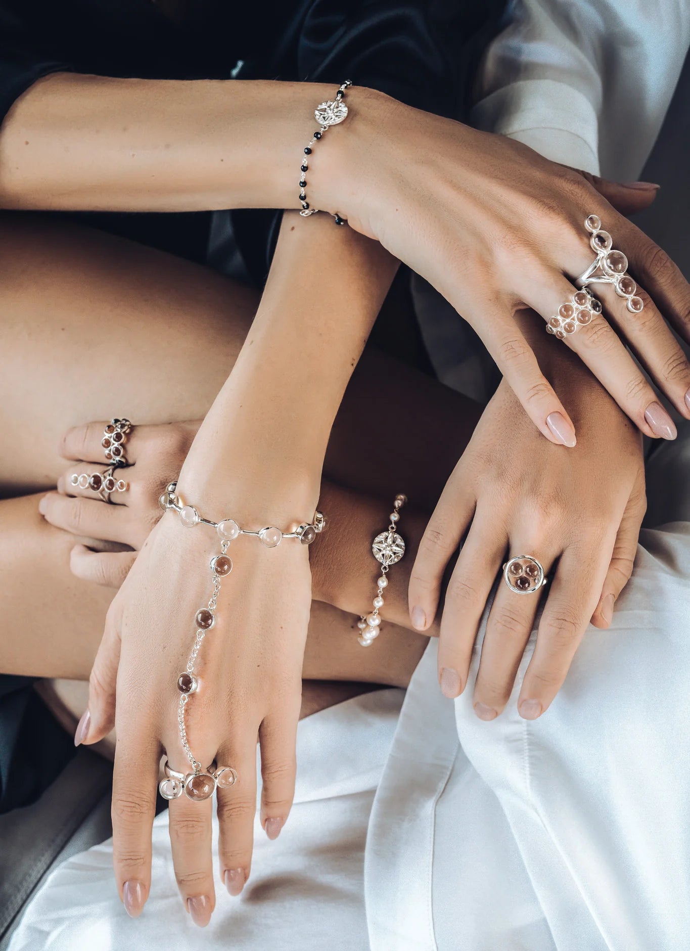 A delicate jewelry collection featuring rings, bracelets and hand-chains