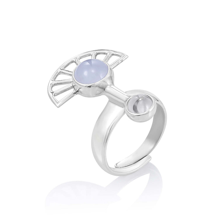 Introducing the Peace of Mind Ring by Kaora Sandara Jewelry, crafted in sterling silver and showcasing an artistic, semi-circular design with a central light blue chalcedony gemstone. A small, hollow cylindrical element beside it adds a modern touch. This unique piece from the Peace of Mind collection features a reflective, polished finish.