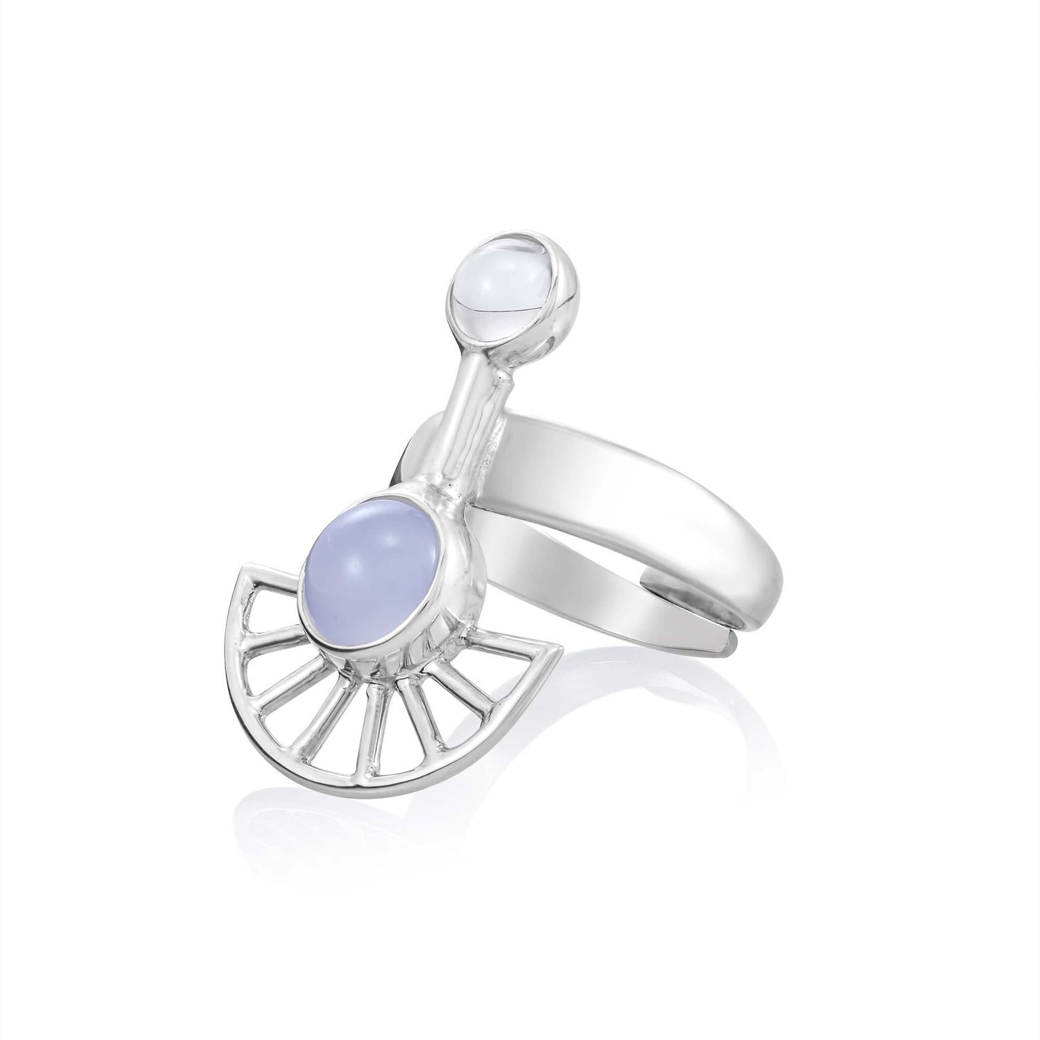 The Peace of Mind Ring from Kaora Sandara Jewelry is a sterling silver masterpiece with an open design featuring two round gemstones. The larger blue chalcedony, often associated with intuition crystals, is set within an arc accompanied by a fan-shaped decoration. The smaller white crystal is elegantly placed on a perpendicular band extending from the center.