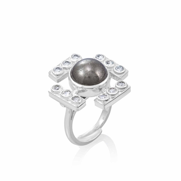 A stunning Confidence Ring from Kaora Sandara Jewelry, this piece showcases a prominent round labradorite gemstone set in the center. The sterling silver band splits into multiple prongs that secure small, circular transparent rhinestone crystals symmetrically on all four sides surrounding the central stone.