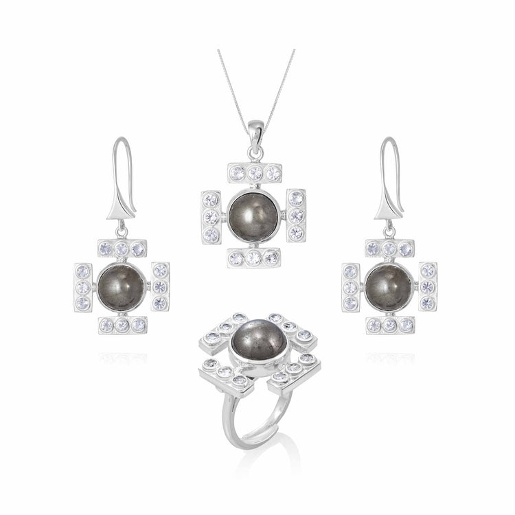 Introducing the Kaora Sandara Jewelry set, which includes a stunning Confidence Ring in sterling silver with crystal and pyrite, alongside a matching necklace and earrings. Each exquisite piece features a central dark stone encircled by rectangular arrangements of transparent rhinestone crystals set in sterling silver. The elegant hook-style earrings and the pendant, which hangs from a delicate silver chain, complete this sophisticated collection.